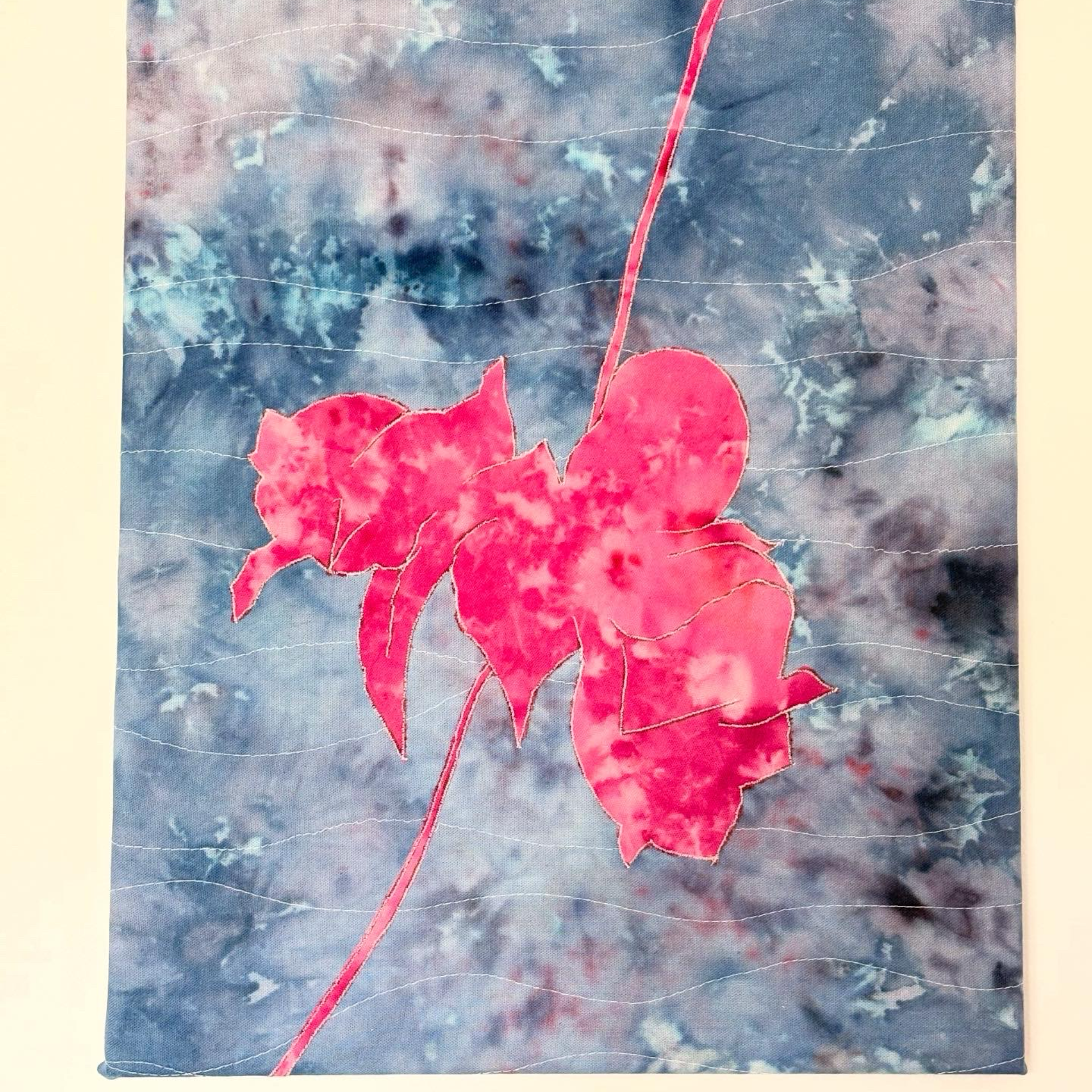 Textile art featuring a flower design