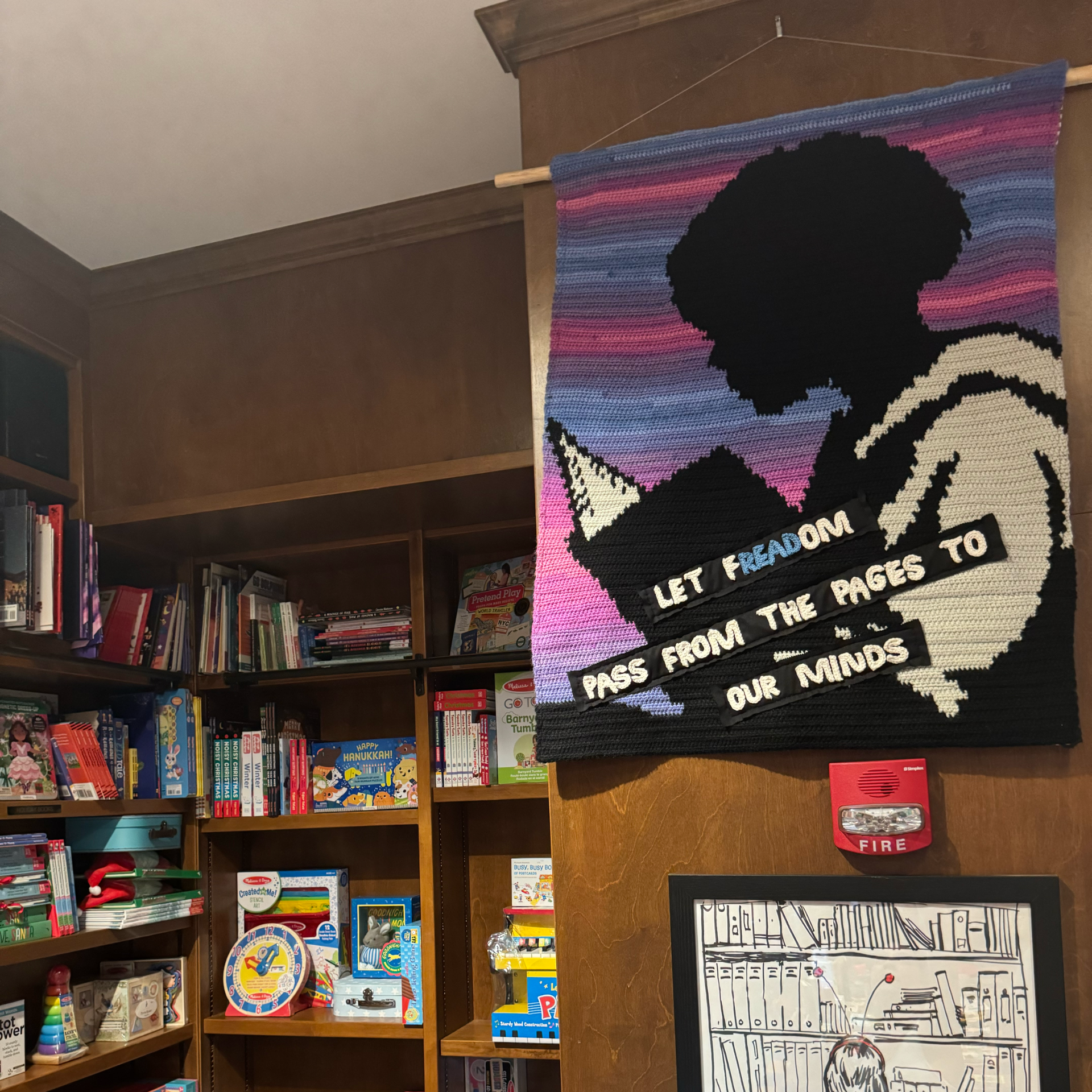 Fiber art with text about freedom and reading
