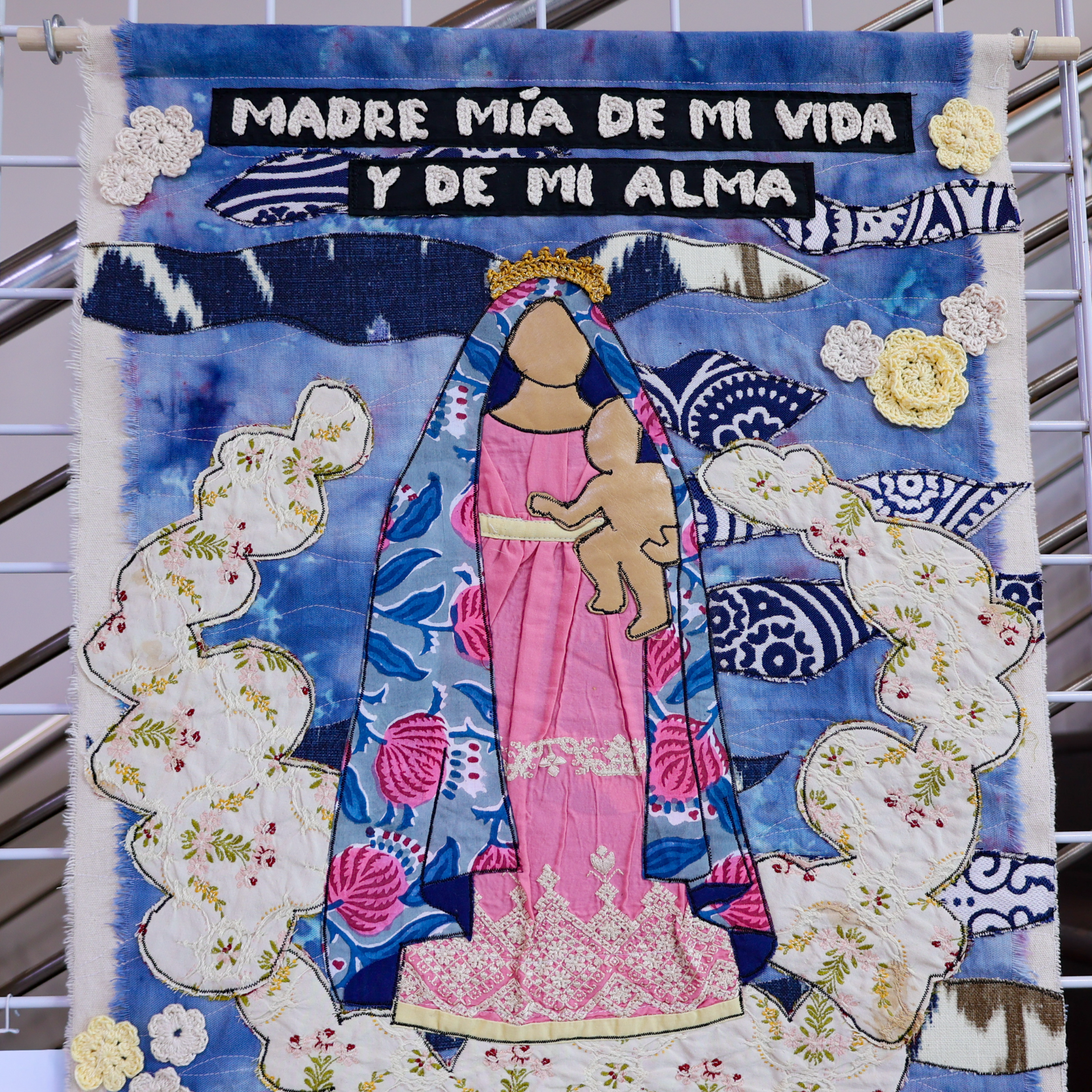 Fiber art tribute piece with Spanish text about mother
