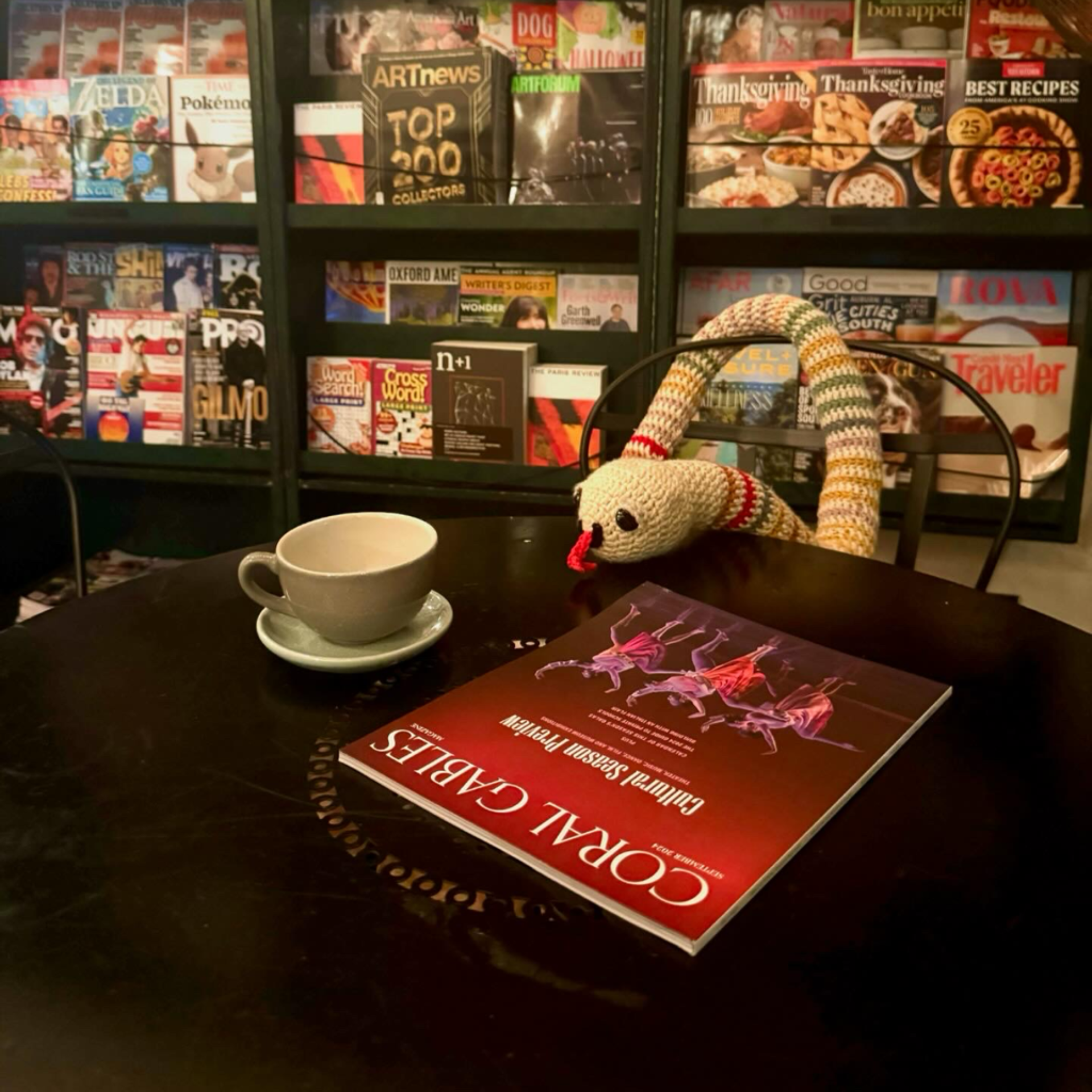 Book worm street art installation with tea and Coral Gables magazine