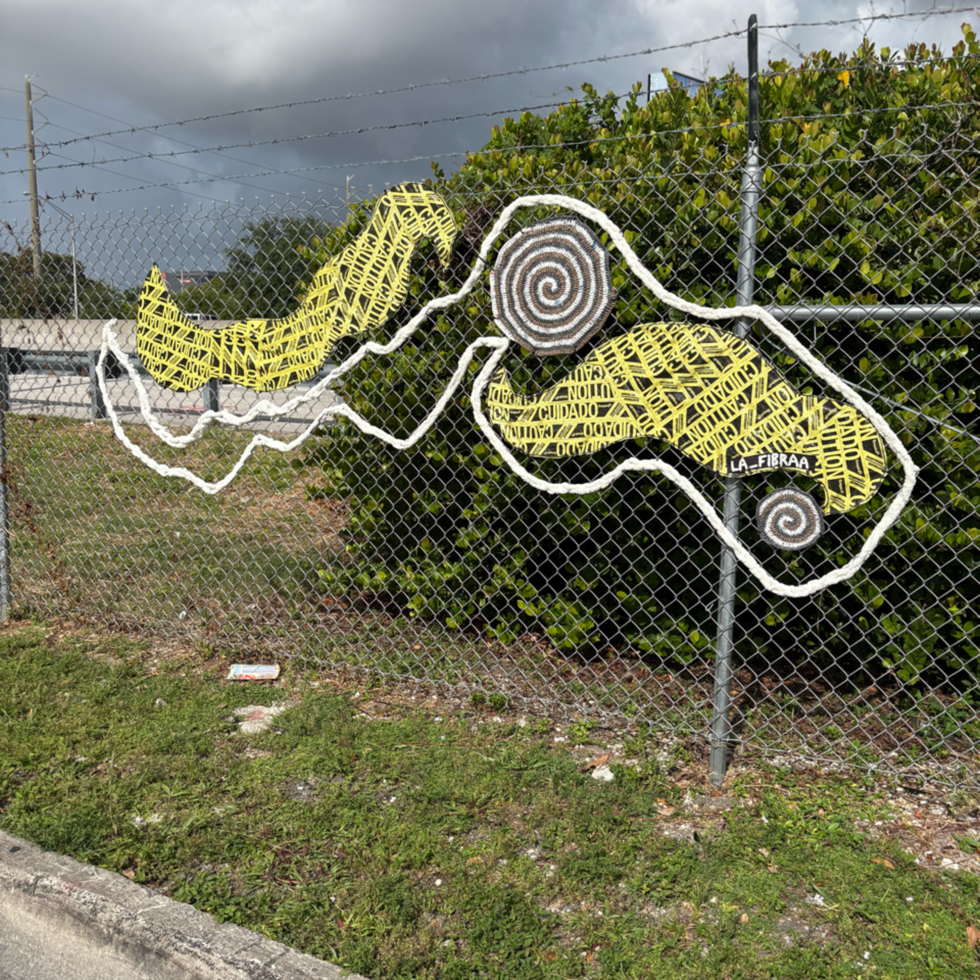 Fiber art installation on fence
